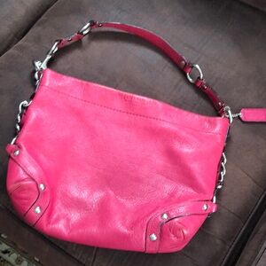 Hot pink Coach purse, gently used. Nicely made w/zipper pockets inside n out